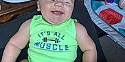 Riven is registered to the contest to win money with this photo: baby, infant, smiling, green_onesie, muscle_text, indoor, toy, baby_gear, wooden_furniture, playmat, happy, child, skin, face, arm, leg, sitting, cute, chubby, expression