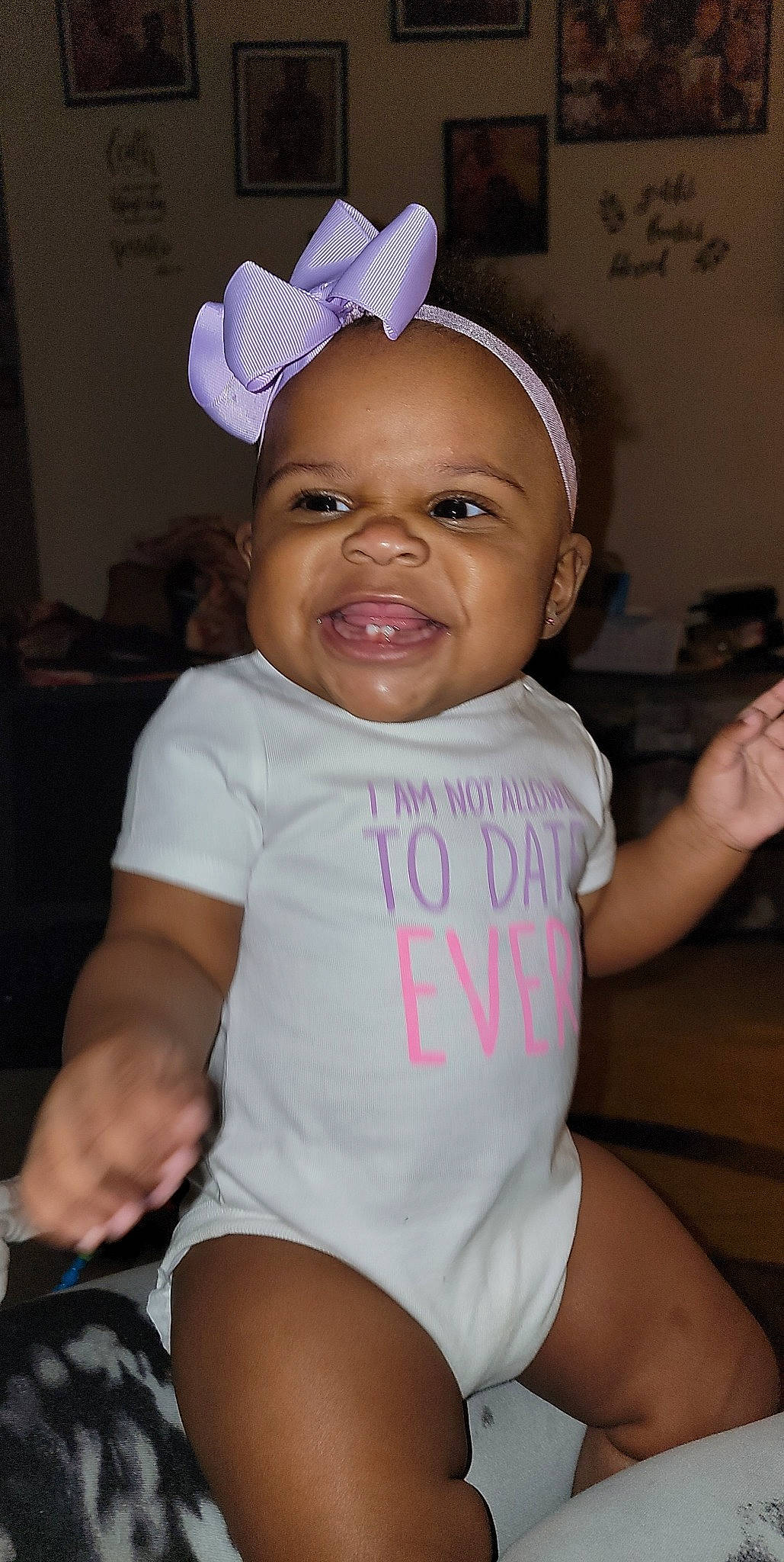 Khloe Kay is registered to the contest to win money with this photo: arm, baby_toddler_clothing, chair, clothing, eye, eyebrow, face, facial_expression, finger, gesture, hairstyle, happy, head, mouth, organ, person, pink, skin, sleeve, smile