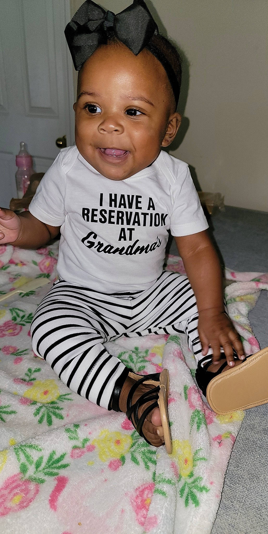 Khloe Kay joined the competition — help win amazing prizes! baby, baby_toddler_clothing, black, cheek, child, comfort, cool, face, happy, iris, joy, neck, pattern, person, product, sitting, skin, sleeve, smile, t_shirt