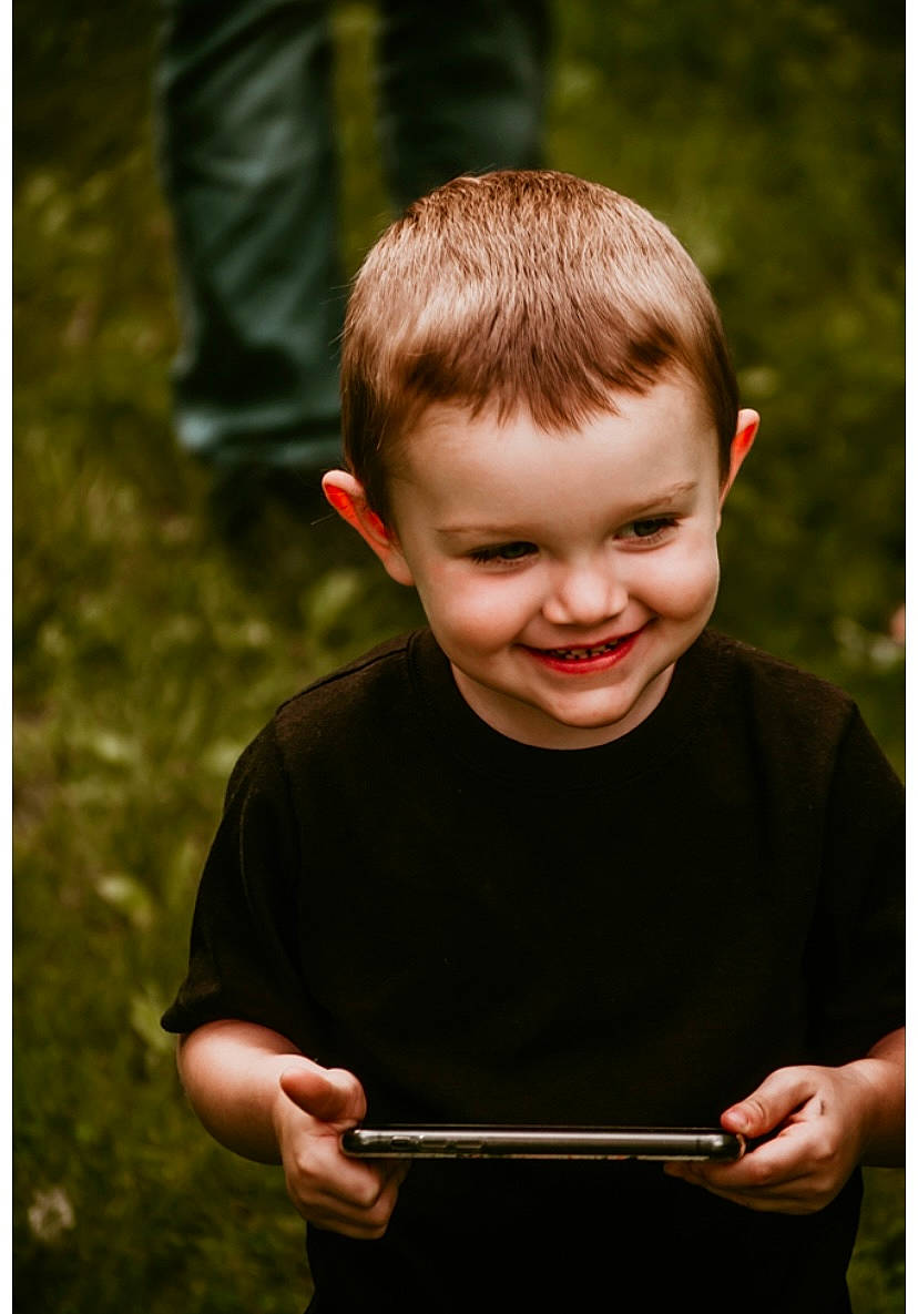 Jalyn is registered to the contest to win money with this photo: child, eye, fun, gesture, grass, hair, happy, head, joy, laugh, leisure, people_in_nature, person, plant, sitting, sleeve, smile, soil, t_shirt, toddler