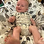 Knox joined the competition — help win amazing prizes! baby, infant, smiling, blanket, onesie, animal_pattern, giraffe, soft_fabric, feet, cute, child, happy, indoor, person, newborn, relaxing, clothing, lying_down, small_hands, cozy