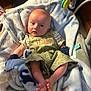 Knox joined the competition — help win amazing prizes! baby, infant, blanket, clothing, overalls, toy, stuffed_animal, face, feet, hand, person, indoor, child, cute, lying_down, blue, green, soft, comfort, baby_bed