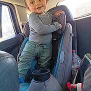 Everett joined the competition — help win amazing prizes! toddler, child, car_seat, vehicle_interior, long_sleeve_shirt, pants, smile, hair, window, water_bottle, shoe, sneaker, seat, car, happy, person, interior, playful, standing, casual