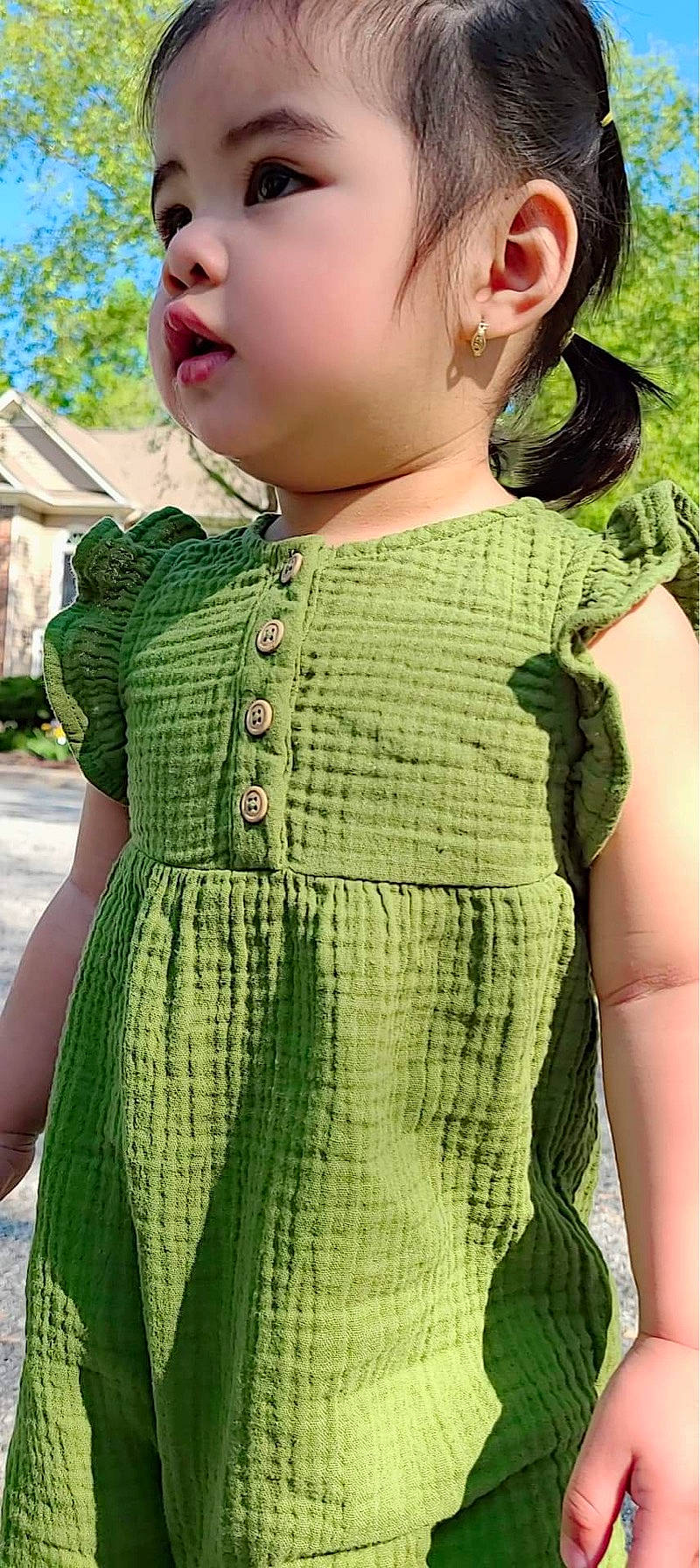 Katie is registered to the contest to win money with this photo: baby_toddler_clothing, button, day_dress, dress, fashion_accessory, grass, green, magenta, neck, outerwear, pattern, person, pink, plant, sleeve, standing, street_fashion, toddler, waist, wool