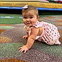 baby, infant, child, crawling, carpet, pink_dress, bow, smile, face, eyes, hands, cute, indoor, mall, seating, bench, pattern, play_area, floor, ground
