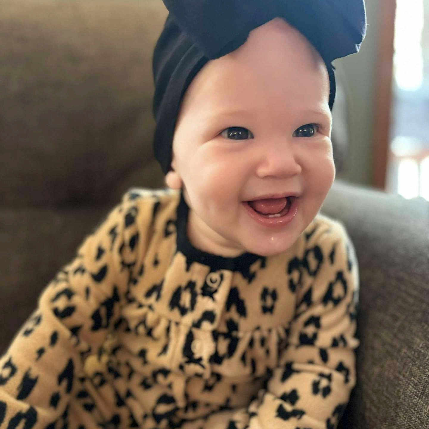 Xayna is registered to the contest to win money with this photo: baby, babylaughing, cap, clothing, face, happy, hat, head, knitwear, laughing, person, photography, portrait, smile, sweater