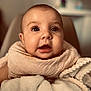 baby, infant, blanket, close_up, face, soft_texture, warm_lighting, cute, child, expression, indoor, portrait, newborn, cozy, wrapped, skin, big_eyes, mouth_open, head, adorable