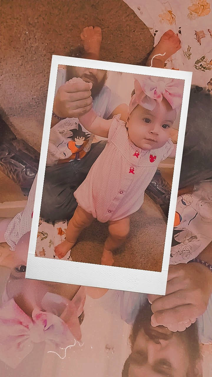 Celeste joined the competition — help win amazing prizes! baby, baby_toddler_clothing, cheek, child, facial_expression, finger, gesture, hand, happy, headwear, nail, pattern, peach, person, photograph, pink, room, skin, sleeve, thumb