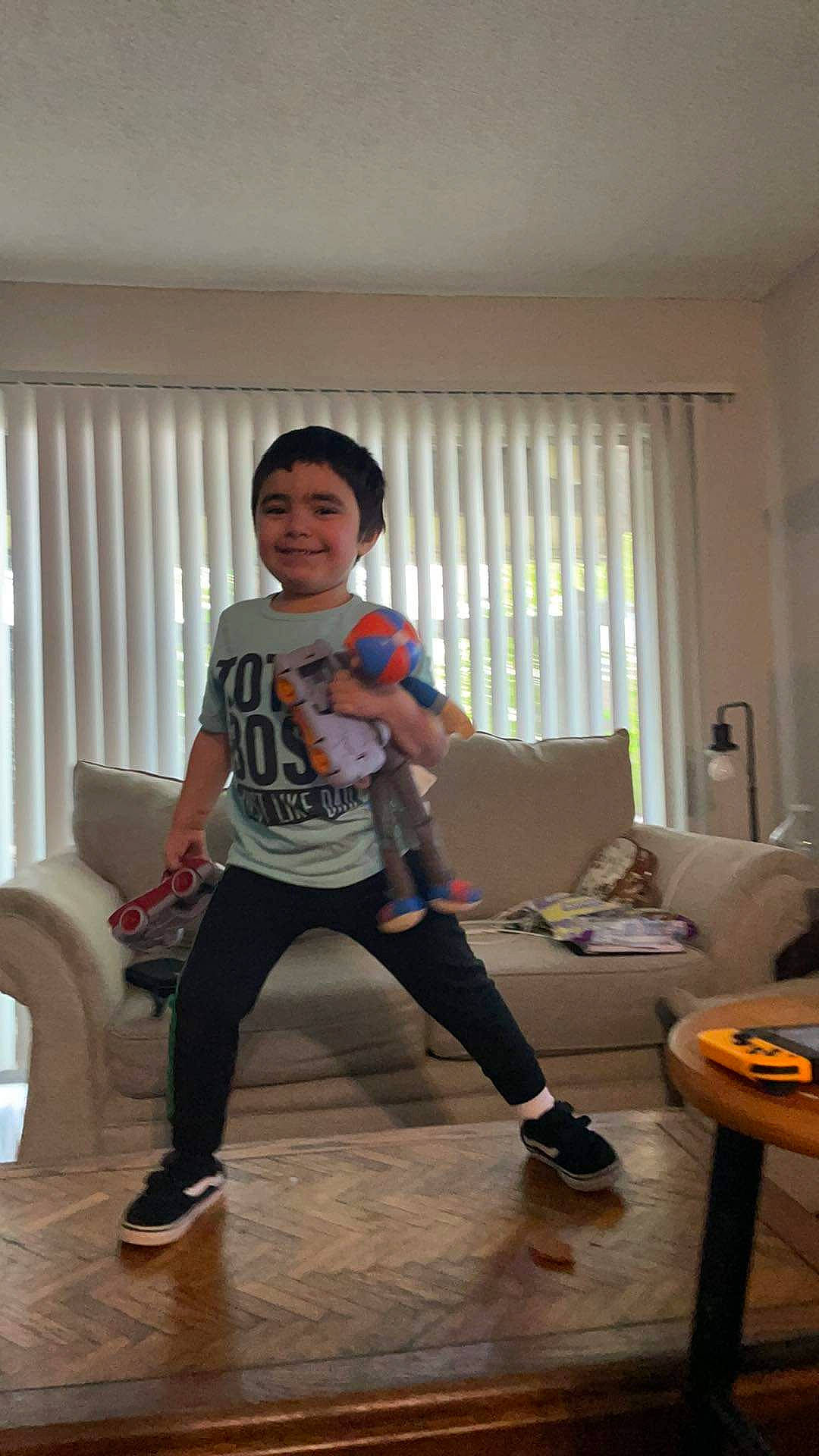 Gustavo joined the competition — help win amazing prizes! curtain, event, flooring, fun, happy, hardwood, joy, knee, leg, leisure, person, shoe, shorts, sitting, sleeve, smile, sneakers, sock, t_shirt, thigh