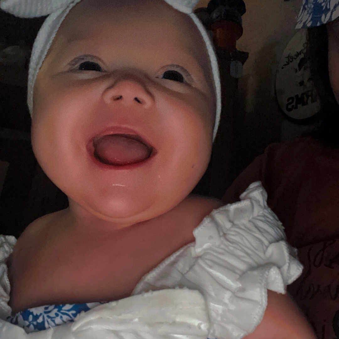 Nova is registered to the contest to win money with this photo: baby, baseballcap, bodypart, bonnet, cap, clothing, diaper, dress, face, happy, hat, head, laughing, mouth, person, photography, portrait, selfie, smile, teeth