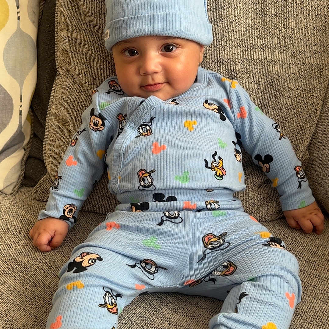 Kaiyan joined the competition — help win amazing prizes! baby, blue_clothing, cartoon_characters, child, comfortable, couch, cozy, cute, ears, face, foot, hand, hat, indoors, infant, playful, portrait, seated, smiling, textured_fabric
