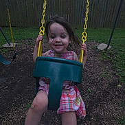 Chloe joined the competition — help win amazing prizes! child, dress, evening, fence, fun, grass, happy, house, nature, outdoor, park, person, plaid, play_equipment, playground, smile, swing, toddler, tree, yellow_chain