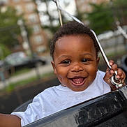 Malachi joined the competition — help win amazing prizes! baby, black_swing, child, clothing, cute, daylight, dimples, face, fun, happy, joyful, metal_chain, outdoor, park, person, playground, smiling, swing, toddler, white_shirt
