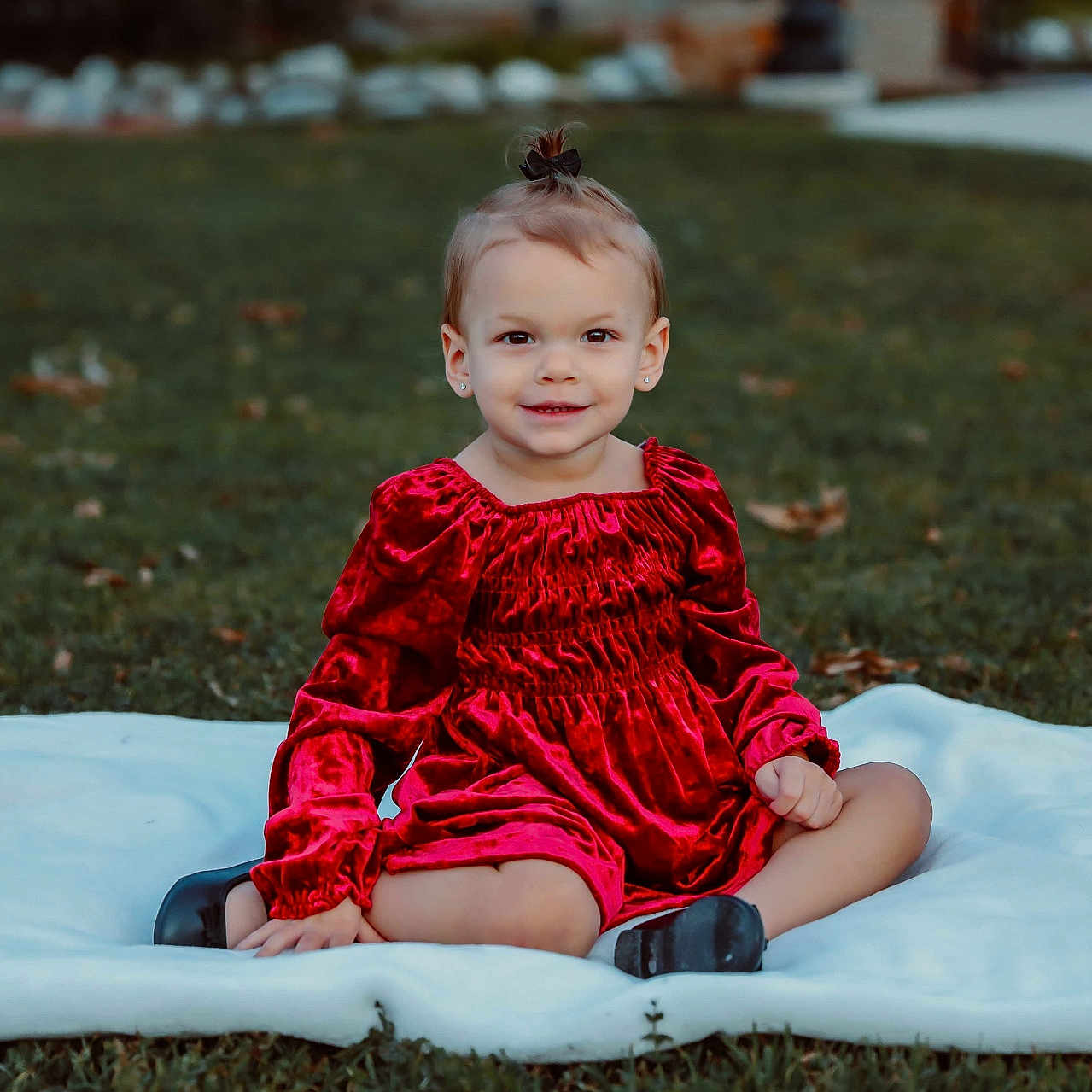 Aleah is registered to the contest to win money with this photo: baby, ball, clothing, dress, face, football, grass, happy, head, lawn, pants, person, photography, plant, portrait, sitting, smile, soccer, soccerball, velvet