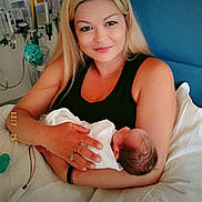 Jayla is registered to the contest to win money with this photo: baby, bed, bedroom, blanket, care, family, healthcare, holding, hospital, indoor, infant, love, medical_equipment, mother, newborn, patient, person, smile, woman, young_baby