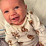 Dominic joined the competition — help win amazing prizes! baby, infant, smiling, cute, blue_eyes, onesie, animal_print, fox, clothing, bed, pillow, happy, child, portrait, face, skin, hand, young, indoors, person