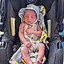 baby, infant, car_seat, blanket, hat, sleeping, child, toddler, cute, resting, peaceful, clothing, foot, hand, portrait, indoors, fabric, seat, comfort, relaxation