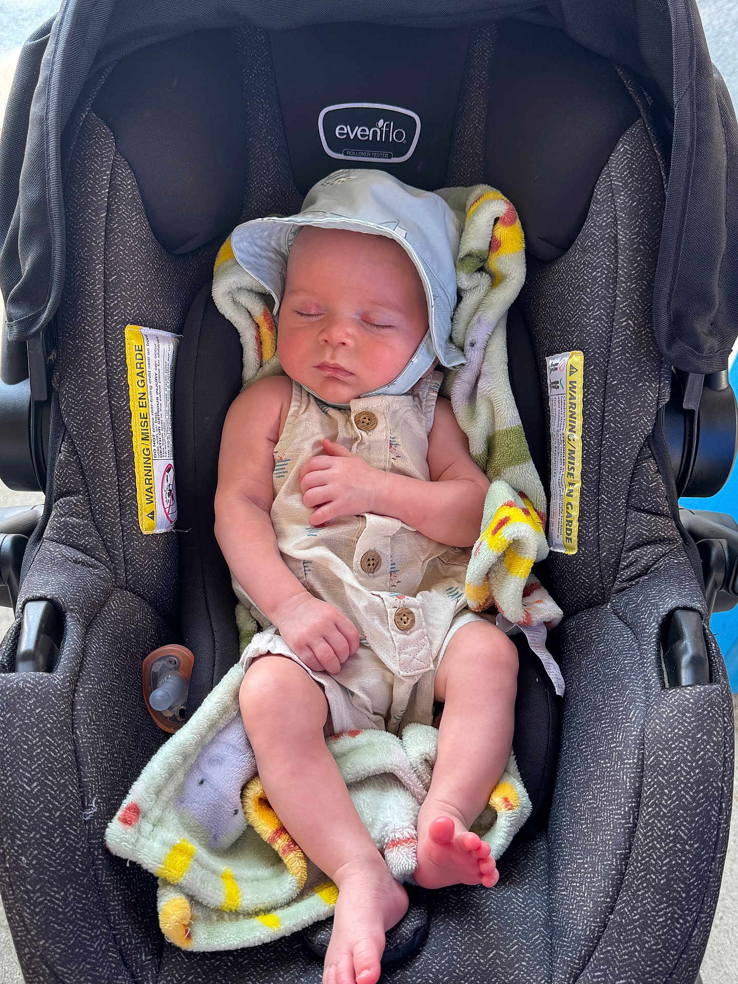 Dominic is registered to the contest to win money with this photo: baby, infant, car_seat, blanket, hat, sleeping, child, toddler, cute, resting, peaceful, clothing, foot, hand, portrait, indoors, fabric, seat, comfort, relaxation