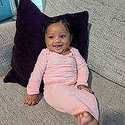 Alani joined the competition — help win amazing prizes! baby, child, smiling, couch, pillow, pink_clothing, indoor, happy, person, infant, portrait, seated, furniture, home, cute, skin, face, hand, foot, cozy