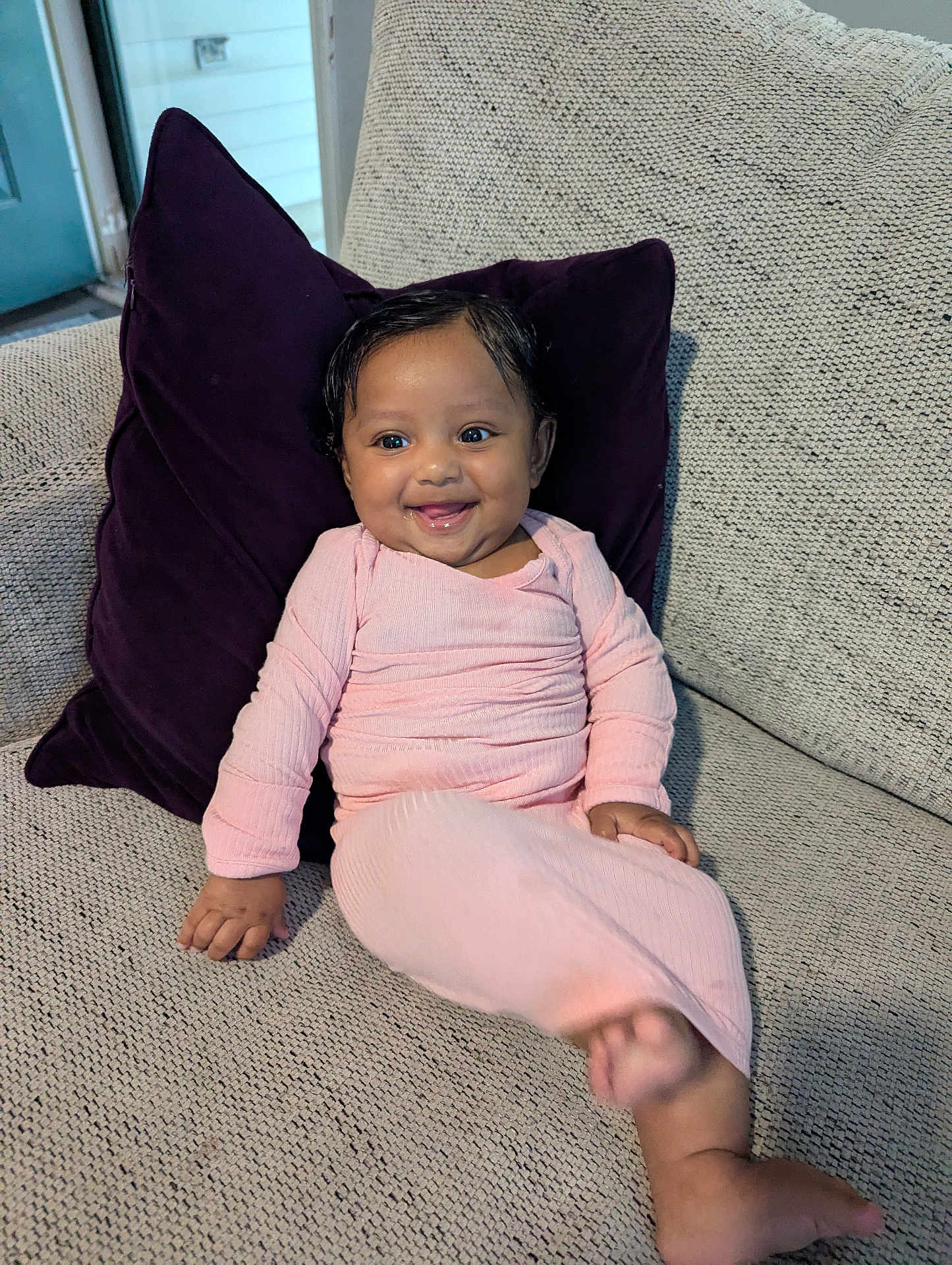 Alani joined the competition — help win amazing prizes! baby, child, smiling, couch, pillow, pink_clothing, indoor, happy, person, infant, portrait, seated, furniture, home, cute, skin, face, hand, foot, cozy
