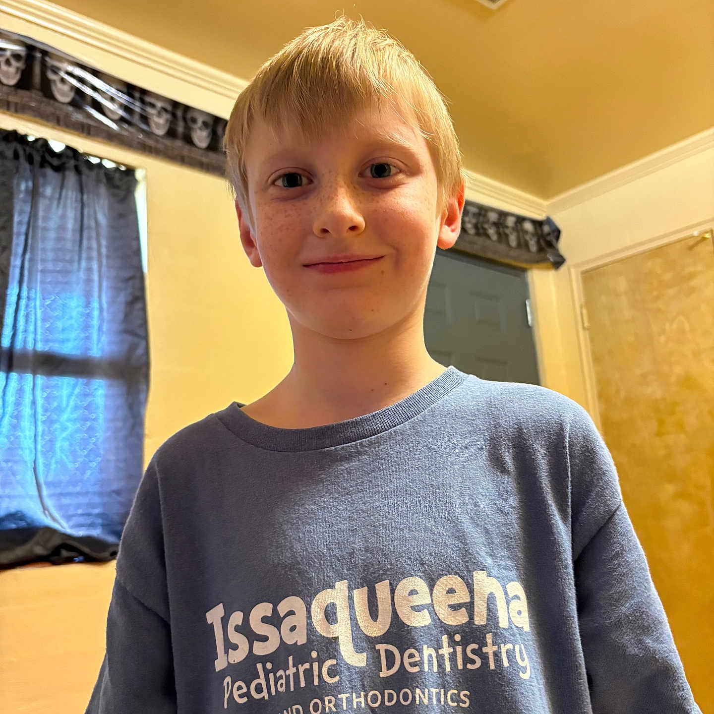 Eugene is registered to the contest to win money with this photo: boy, casual, ceiling, child, clothing, curtains, door, freckled_face, freckles, indoor, light, pediatric_dentistry, person, portrait, short_hair, smile, tshirt, wall, window, young