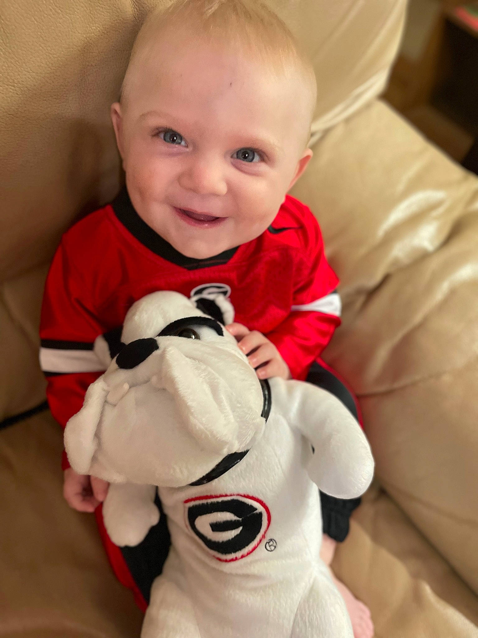 Cole is registered to the contest to win money with this photo: arm, baby, baby_toddler_clothing, cheek, comfort, eye, face, finger, gesture, hairstyle, happy, head, human_body, mammal, mouth, organ, person, skin, sleeve, smile