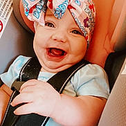 Blakelee is registered to the contest to win money with this photo: baby, smiling, car_seat, headwrap, child, infant, safety_harness, happy, cute, apparel, portrait, seat, straps, person, closeup, indoors, skin, hand, face, young_child