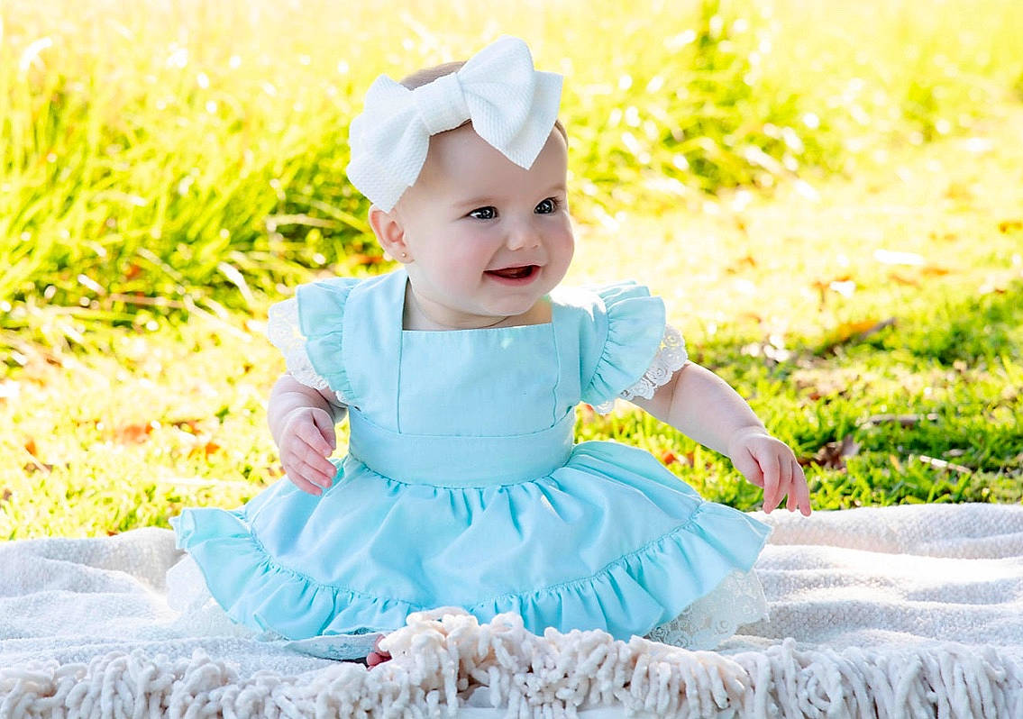 Collins is registered to the contest to win money with this photo: baby, baby_bloomers, baby_products, baby_toddler_clothing, ballet_tutu, child, clothing, costume, costume_accessory, dress, hair_accessory, headband, headgear, headwear, person, pink, product, ruffle, textile, toddler
