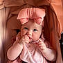 Madison is registered to the contest to win money with this photo: baby, child, infant, pink_bow, pink_clothing, bib, stroller, blue_eyes, hand, food, cute, chubby_cheeks, portrait, indoor, cushion, seat_belt, close_up, skin, expression, munching