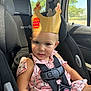 Athena is registered to the contest to win money with this photo: toddler, child, car_seat, burger_king_crown, pink_dress, car_interior, seatbelt, safety_harness, window, sunlight, cute, portrait, car, seat, child_safety, baby, young_child, smile, face, summer