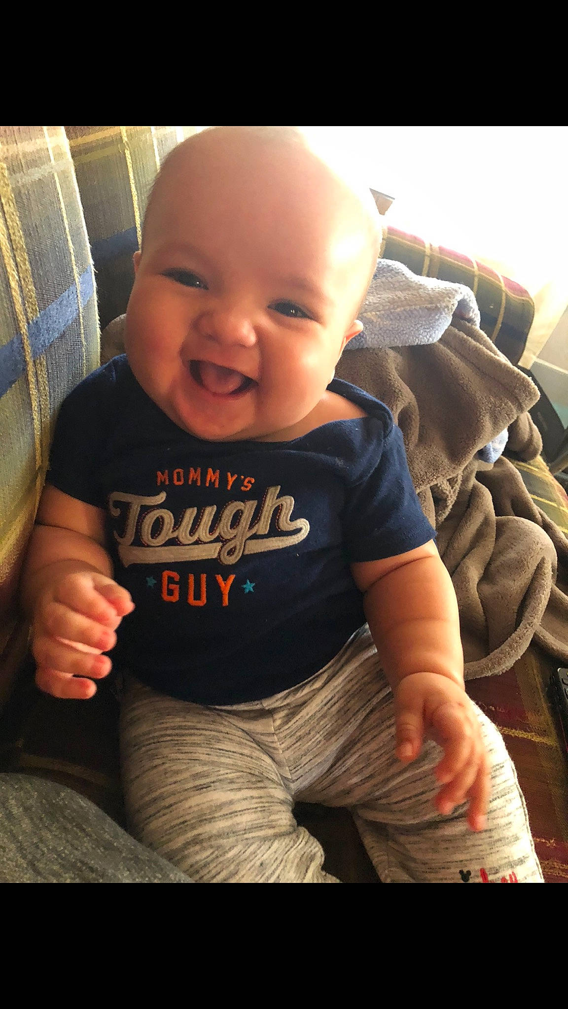 Malikai is registered to the contest to win money with this photo: baby, cheek, child, cool, muscle, person, sitting, skin, sleeve, smile, t_shirt, toddler