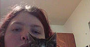 Bandit is registered to the contest to win money with this photo: person, cat, kitten, indoor, selfie, face, hand, cabinet, wall, light, hair, eye, nose, mouth, sitting, holding, domestic_animal, feline, pet, closeup