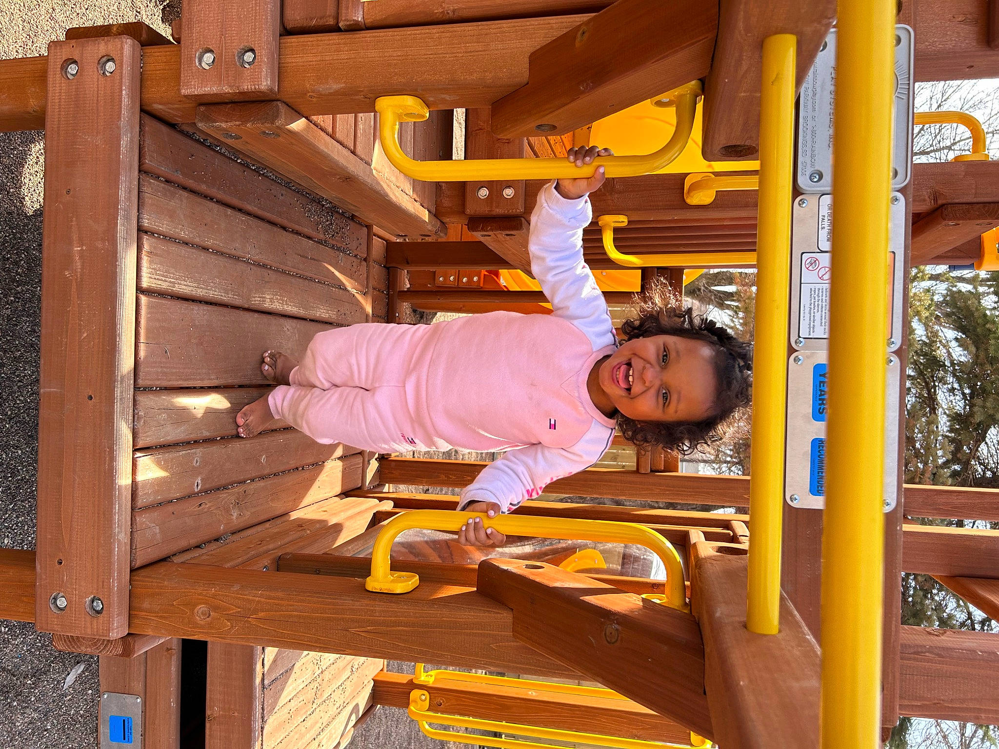 Brooklyn is registered to the contest to win money with this photo: baby_toddler_clothing, child, city, fun, hardwood, leisure, machine, metal, outdoor_play_equipment, person, playground, recreation, smile, toddler, travel, wood, wood_stain