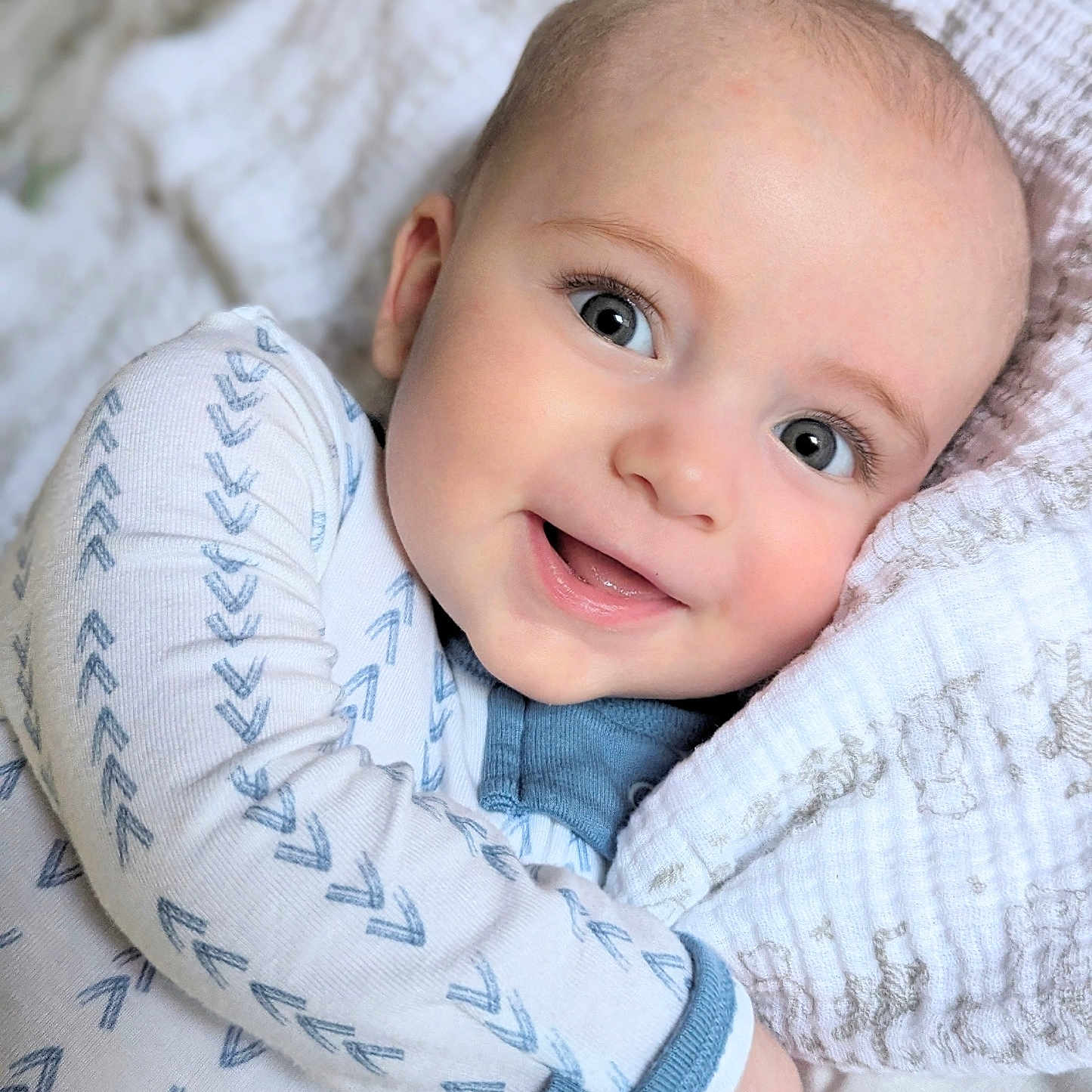 Marlowe is registered to the contest to win money with this photo: baby, babylaughing, blanket, bodypart, clothing, cushion, face, finger, hand, happy, head, homedecor, knitwear, laughing, newborn, person, photography, portrait, smile, sweater
