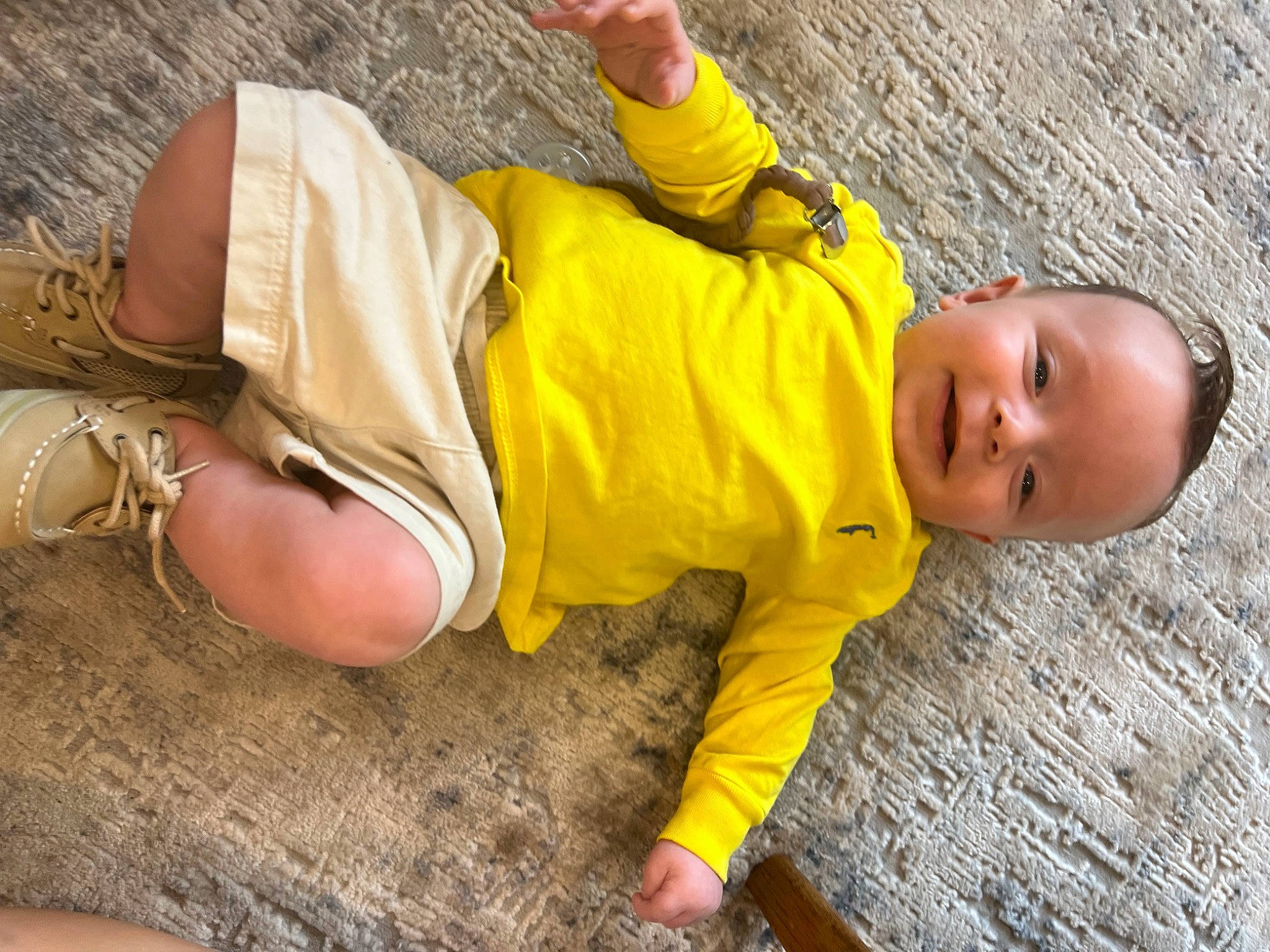 Shepherd is registered to the contest to win money with this photo: adaptation, child, flooring, fun, grass, hand, happy, headgear, human_body, joy, leg, leisure, person, plant, sand, shorts, sitting, skin, thigh, toddler
