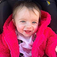 Kélya participe au concours pour gagner de l'argent avec cette photo : baby, child, smiling, pink_jacket, fluffy_clothing, cute, portrait, face, happy, infant, clothing, jacket, seated, closeup, person, young_child, bright_colors, warm_clothing, indoor, expression