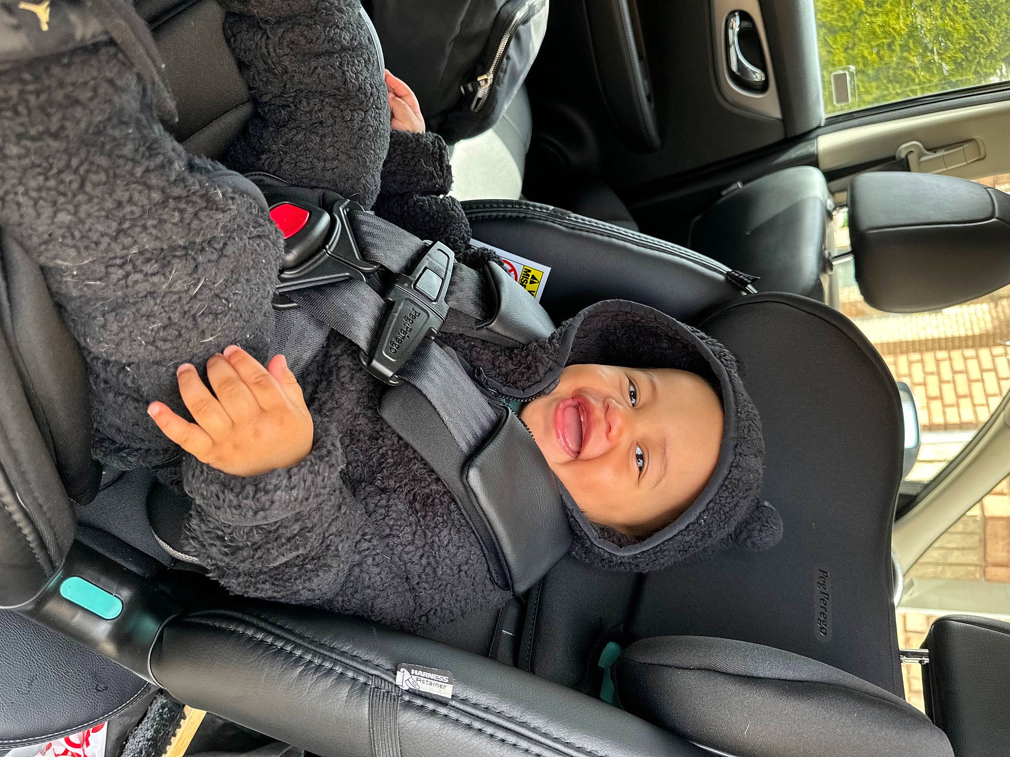 Aura is registered to the contest to win money with this photo: auto_part, automotive_design, automotive_exterior, automotive_tire, car, car_seat, car_seat_cover, fender, head_restraint, headwear, mode_of_transport, motor_vehicle, person, plant, seat_belt, smile, steering_part, steering_wheel, vehicle, vehicle_door
