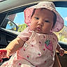 Alahia is registered to the contest to win money with this photo: baby, child, pink_dress, hat, strawberry_pattern, car_interior, sunlight, window, blue_sky, greenery, face, arm, cute, portrait, infant, clothing, summer, outdoor_view, person, seat