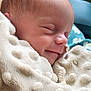 Emy participe au concours pour gagner de l'argent avec cette photo : baby, blanket, child, closeup, comfort, cozy, cute, face, head, indoors, infant, newborn, peaceful, portrait, resting, skin, sleeping, smiling, soft_texture, wrapped
