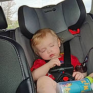 Roxas is registered to the contest to win money with this photo: baby, bottle, car_interior, car_seat, child, child_safety_seat, daylight, infant, inside_car, peaceful, red_shirt, relaxed, safety, seat, seatbelt, sleeping, toddler, white_socks, window, young_child