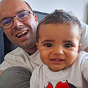 Mélina joined the competition — help win amazing prizes! baby, child, man, adult, smiling, glasses, white_shirt, minnie_mouse, portrait, indoor, happy, family, closeup, casual, person, cute, face, people, baby_clothing, tshirt