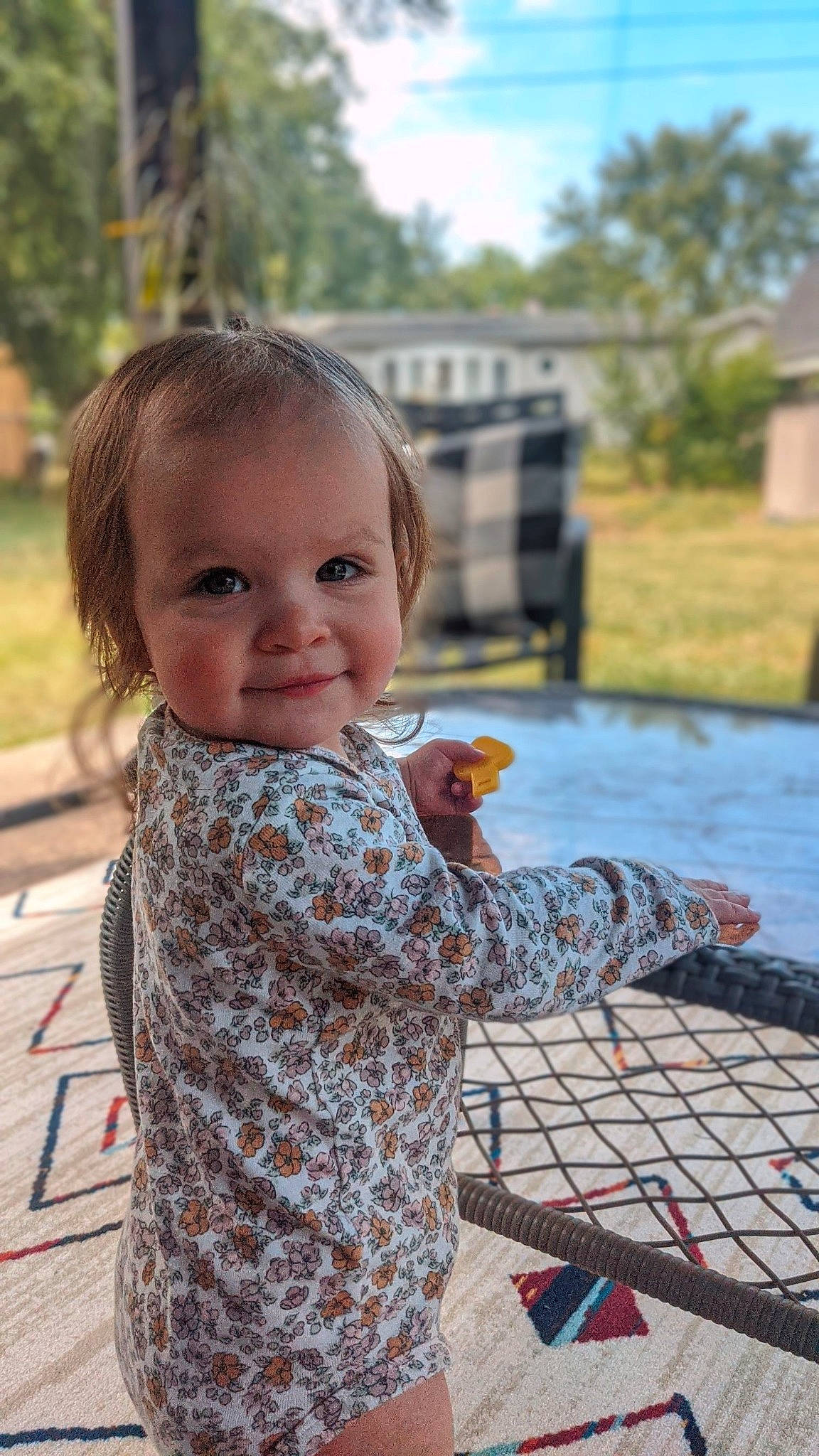 Esme is registered to the contest to win money with this photo: child, city, face, flooring, fun, grass, happy, leisure, pattern, people, person, plant, play, recreation, sitting, smile, summer, toddler, tree, vacation