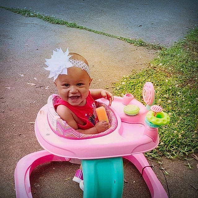 Macey is registered to the contest to win money with this photo: baby, baby_laughing, baby_products, baby_toddler_clothing, chair, child, comfort, fun, grass, happy, headwear, lap, leisure, magenta, people_in_nature, person, pink, recreation, sitting, smile