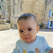 Nathaniel participe au concours pour gagner de l'argent avec cette photo : baby, child, face, outdoor, expression, pout, shirt, building, window, stone_wall, blue_shutters, person, portrait, daylight, cute, infant, casual_clothing, curious, young, head