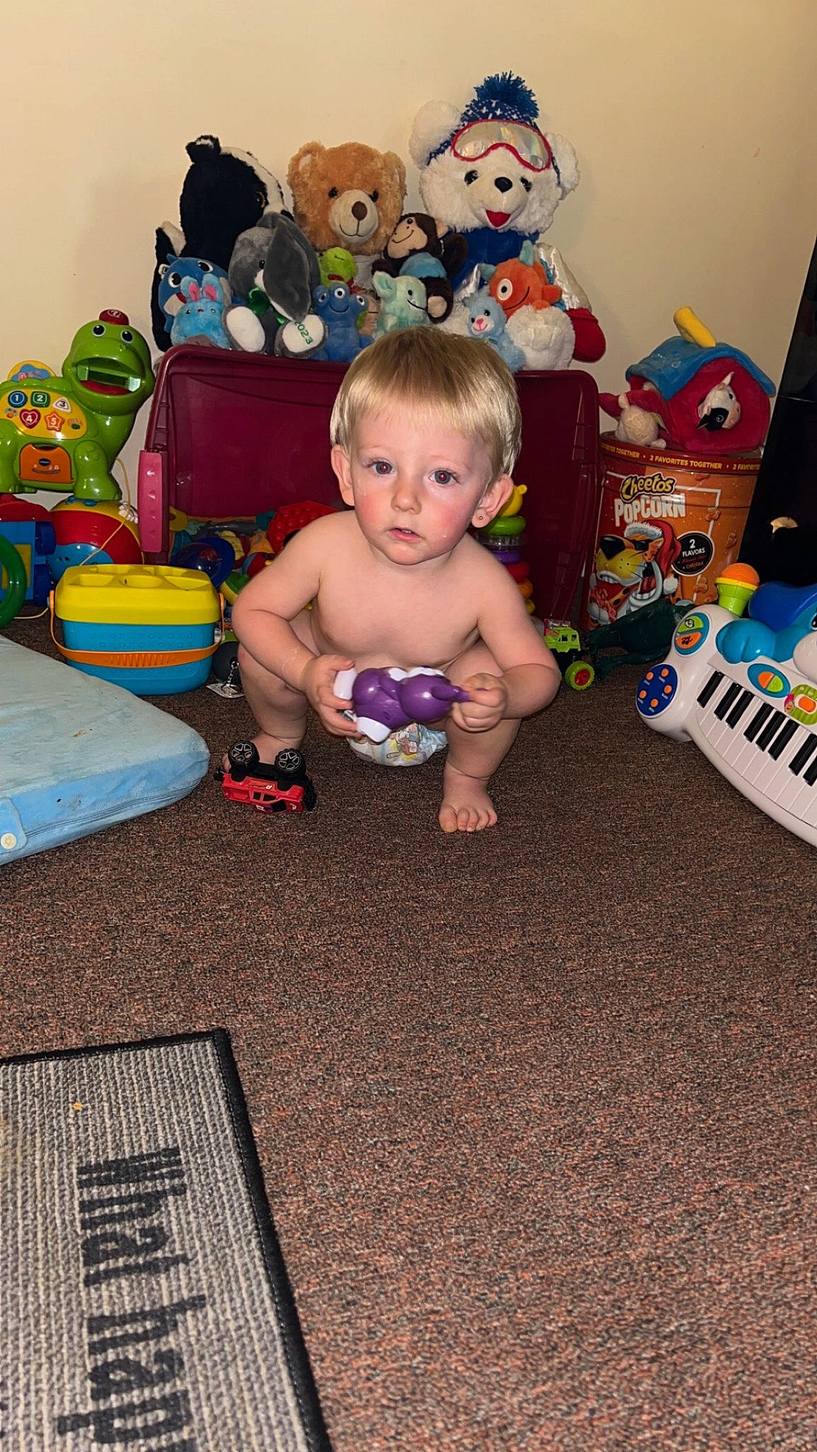 Austyn Jr is registered to the contest to win money with this photo: baby, baby_toddler_clothing, baby_toys, chair, child, event, floor, flooring, fun, happy, head, holiday, human_leg, lap, living_room, person, room, sitting, stuffed_toy, toddler
