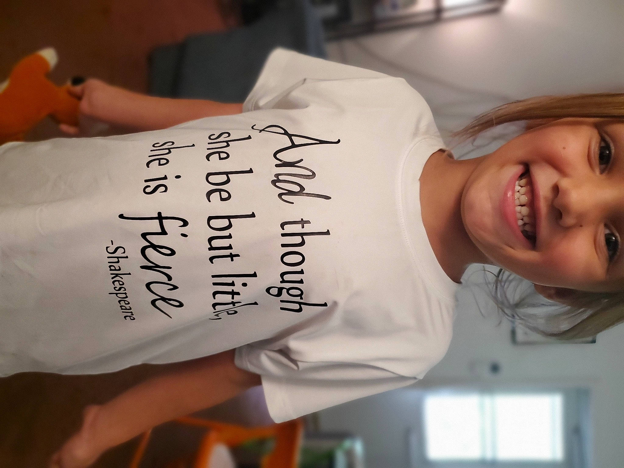 April is registered to the contest to win money with this photo: elbow, eyelash, font, hair, happy, joy, person, sleeve, smile, t_shirt, window, wrist