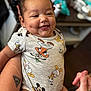 baby, child, smiling, dimples, onesie, disney, mickey_mouse, donald_duck, goofy, cute, happy, portrait, chubby_cheeks, indoor, person, hand, holding, blurred_background, clothing, infant