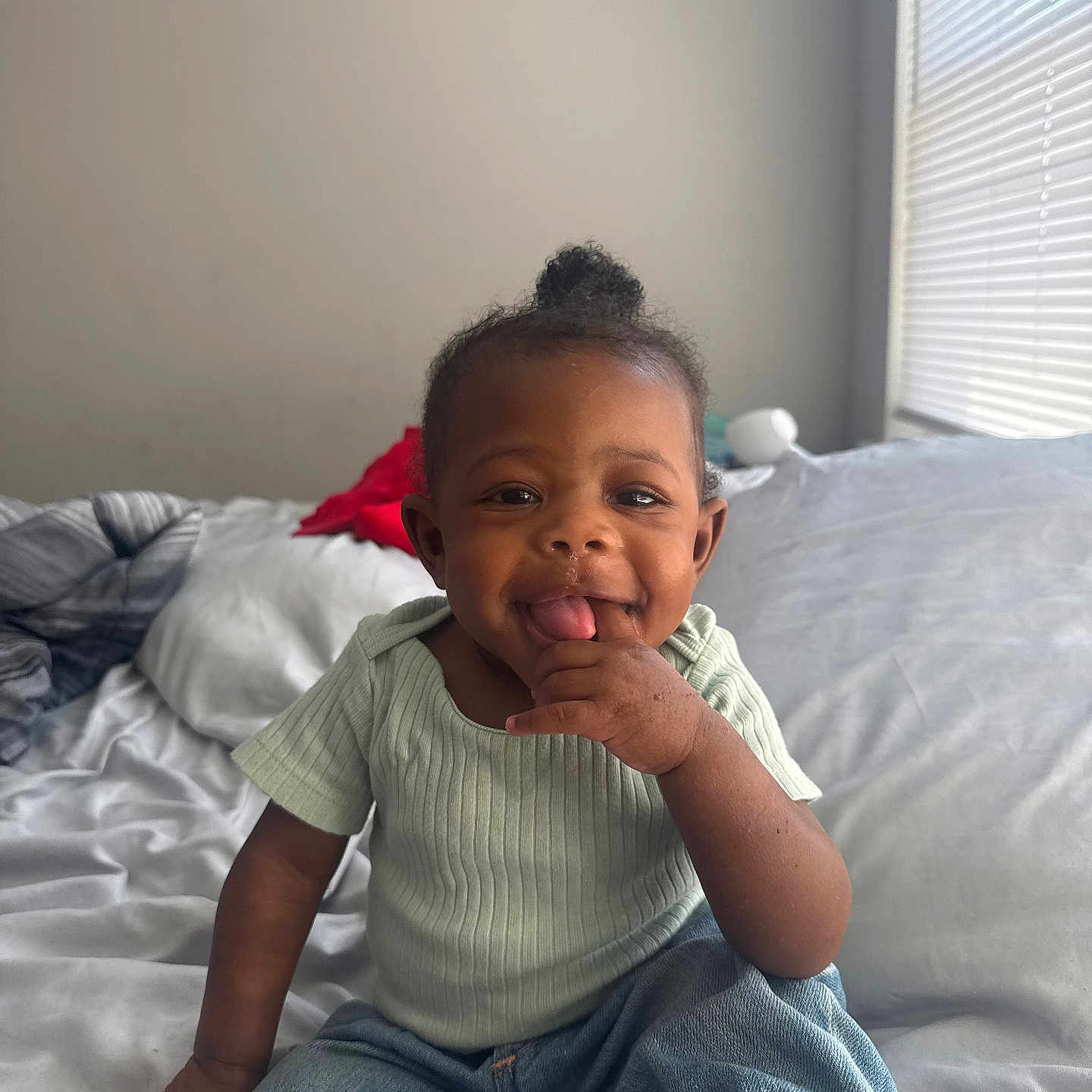 Delani is registered to the contest to win money with this photo: baby, bed, bedroom, bodypart, clothing, couch, face, finger, furniture, hand, happy, head, homedecor, indoors, pants, person, photography, portrait, sitting, smile