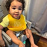 Egypt joined the competition — help win amazing prizes! toddler, child, baby, curly_hair, smiling, portrait, high_chair, yellow_bib, eating, food, crumbs, indoor, home, curtains, wooden_floor, seated, barefoot, happy, face, photography