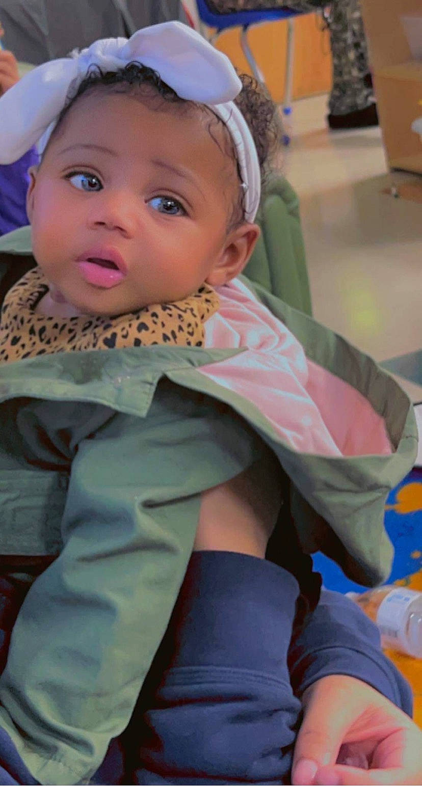 Kyndall is registered to the contest to win money with this photo: baby, cap, cheek, child, event, eye, face, fashion_accessory, fun, happy, headgear, leisure, mouth, person, personal_protective_equipment, pink, recreation, sitting, skin, toddler